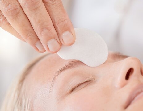 Hand gently placing a plain white eye patch over a closed eye for gentle eye care