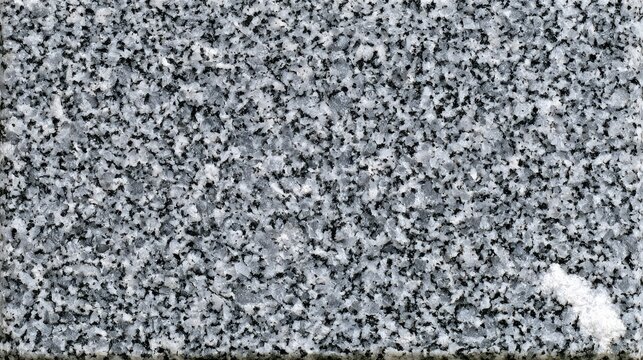 A textured granite surface with flecks of grey, black, and white