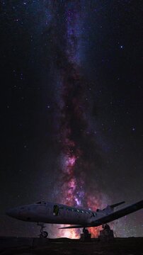 Night landscape, old airplane on the bright Milky Way background. Time lapse.