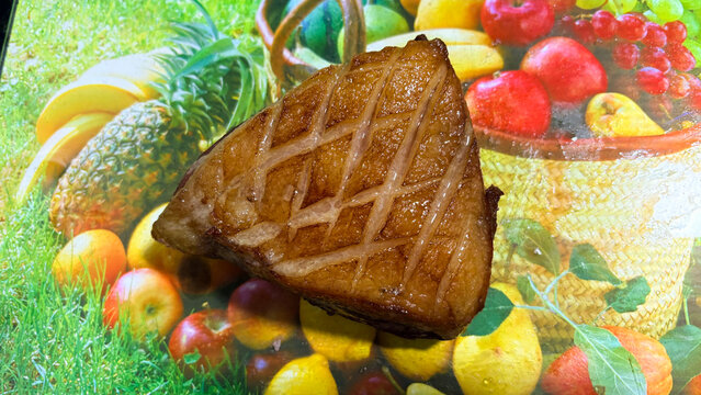 Sirloin steak cooked golden brown on printed fruit background