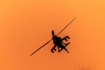 Fototapeta premium Close-up of helicopter is turning on isolated sky during dawn