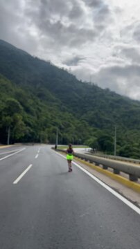 Young woman jogging on mountain road with copy space