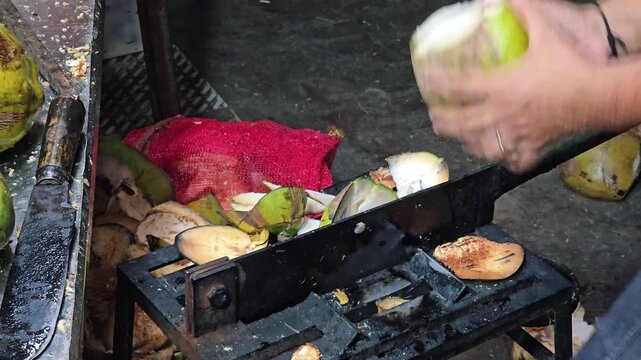 In Kerala, karikku vendors shave green husks on heavy blades with rapid speed. A sharp chop punctures the core, spraying sweet water before the finished coconut joins a row of refreshing street drinks