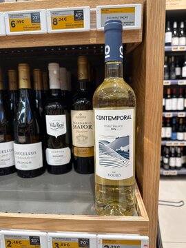 Contemporal Douro white wine bottle presented at the front of a supermarket shelf with digital price labels and other Portuguese vintages behind for local shoppers, 4 April 2026, Sintra, Portugal