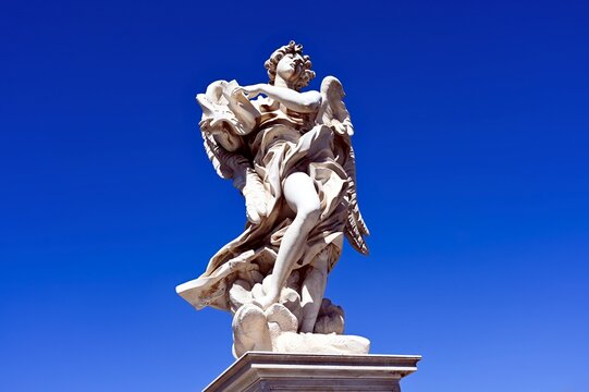 Beautiful white stone sculpture of an angel on the Ponte Sant'Angelo bridge in Rome, Italy. beautiful white stone angel sculpture of an angel on the Ponte Sant'Angelo bridge on the Tiber river in Rome