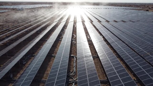 Aerial view of vast solar farm photovoltaic panels in desert landscape a high-angle drone shot capturing rows