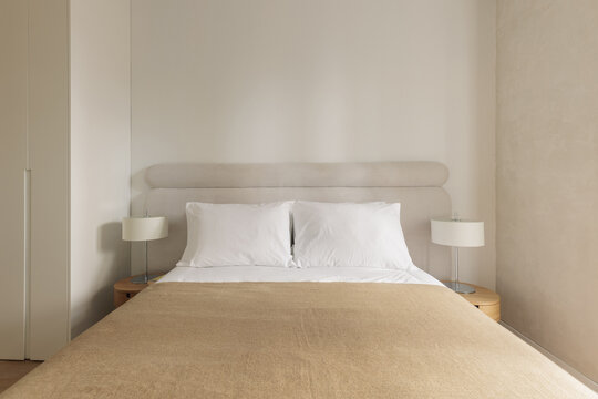 Symmetric bedroom with built-in wardrobe and matching lamps