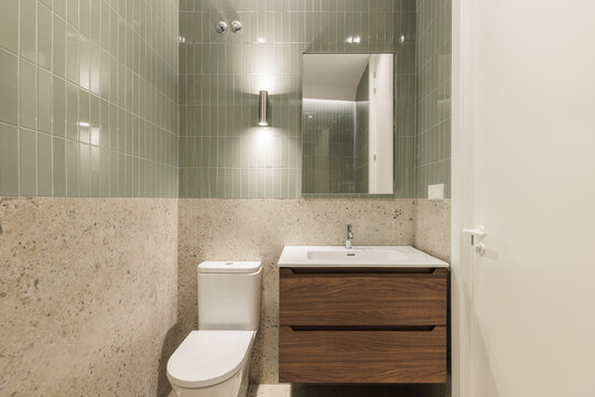 Full bathroom with rain shower head and sage green tiles