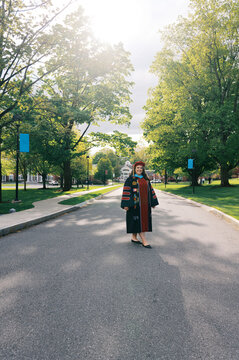 smiling latina doctorate on graduation day in all her regalia