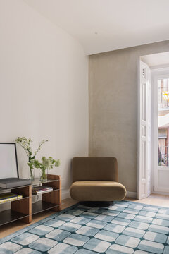 Mustard armchair with media unit and balcony door