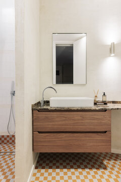 Bathroom with hydraulic checkerboard floor and walnut vanity