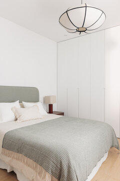 Sage green bedroom with lantern pendant lamp