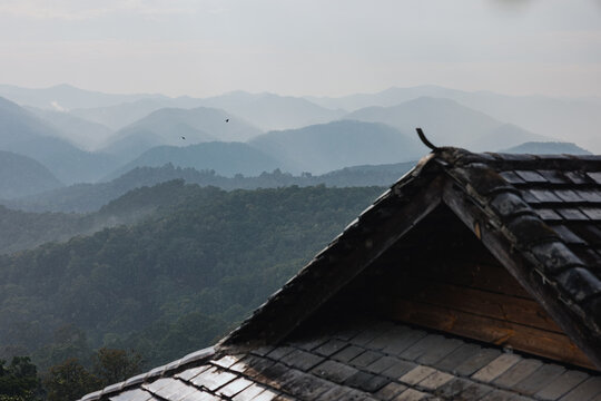 Traditional Roof with Layered Mountain Landscape