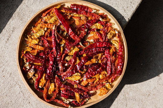 Dried Red and Yellow Chili Peppers Drying in Sunlight