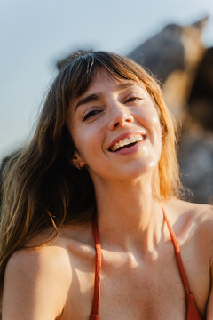 Happy woman wearing red bikini outdoors