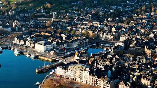 Aerial view over Honfleur town center and waterfront, with boats and historic buildings forming classic Normandy urban scene