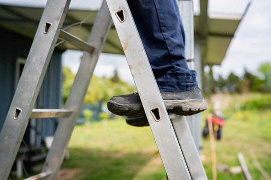 Worker climbing ladder