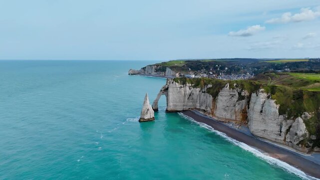 Famous Etretat coastline in Normandy, France, with limestone cliffs above English Channel. Drone view for travel, tourism and nature content