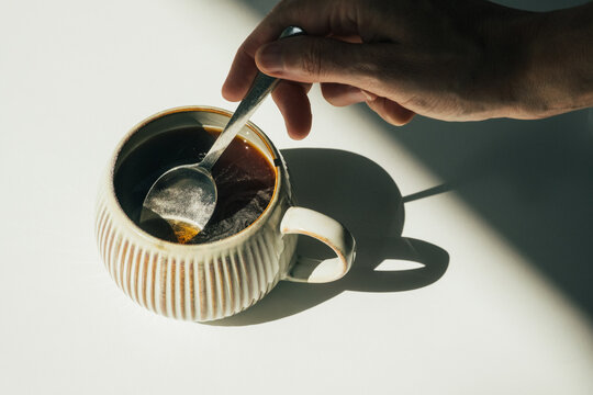 Stirring Collagen Supplement into Coffee