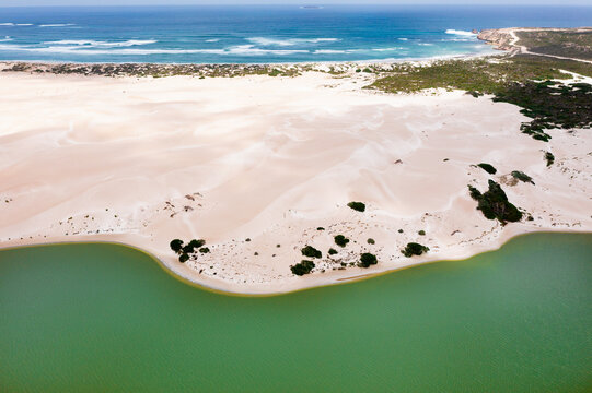 White sand dunes between the ocean and a coastal lagoon