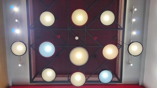 Industrial pendant light and ceiling spotlight illuminating a modern interior, featuring functional lighting fixtures for commercial architecture, retail design, and contemporary decor.