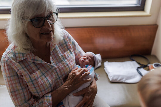 Grandmother Cradling Newborn in Hospital