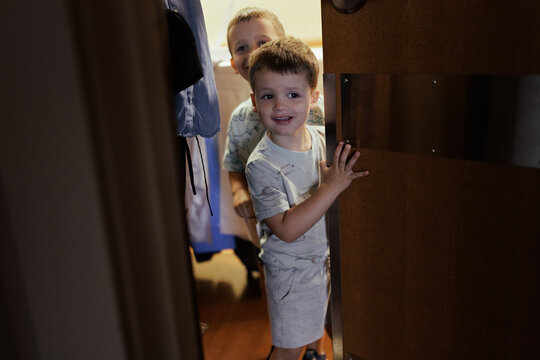 Children Peeking Around Door