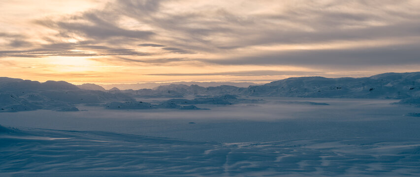 Panoramic Arctic Winter Landscape at Sunrise Over Frozen Valley