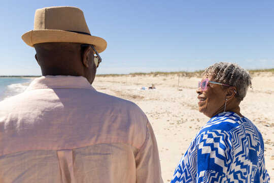 Active Senior Black Couple connect walk beach 