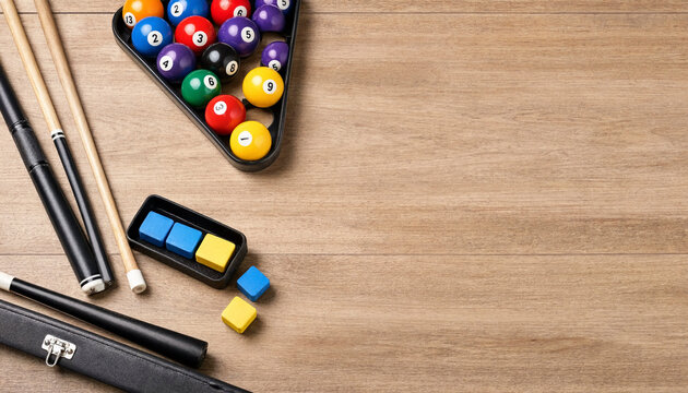 Billiard equipment arranged on a wooden table, showing racked pool balls, cue sticks, chalk cubes and a case. Composition leaves ample copy space for text or layout use.