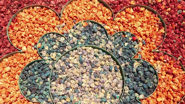 Colorful Dried Flowers and Spices Arranged in Flower-Shaped Display for Market or Decor