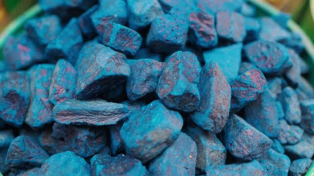 Bright Blue Dyed Rocks Pile in Bucket Close-Up Showing Texture and Vivid Color Contrast