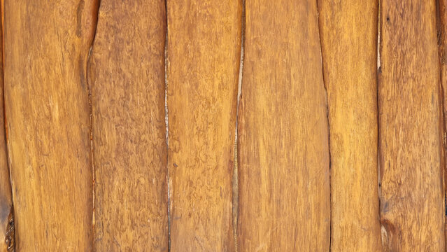 Natural vertical wooden plank wall with irregular board edges and visible wood grain texture