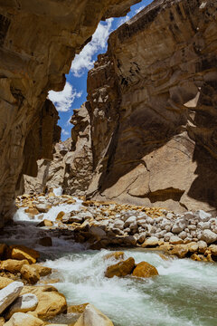 Dramatic Himalayan Mountain Canyon with Turquoise River Flowing Through Rugged Rock Cliffs