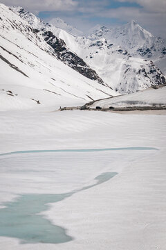 Shinku La Pass View with Snow-Covered Himalayan Peaks, Winding Road and Frozen Alpine Landscape