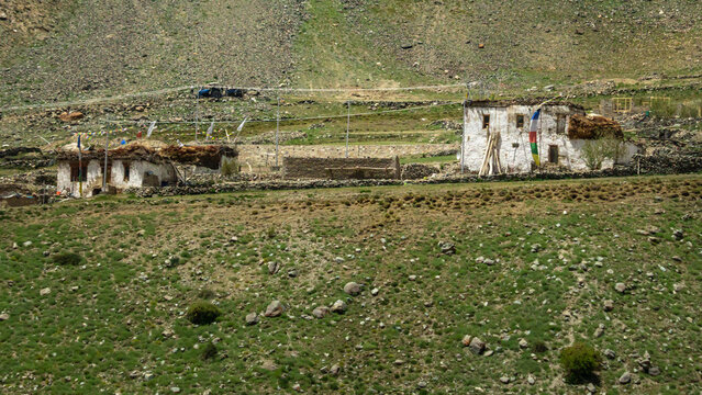 Traditional Whitewashed Mud and Stone Houses with Prayer Flags in Remote High Altitude Village, Rural Himalayan Settlement in Zanskar Ladakh India