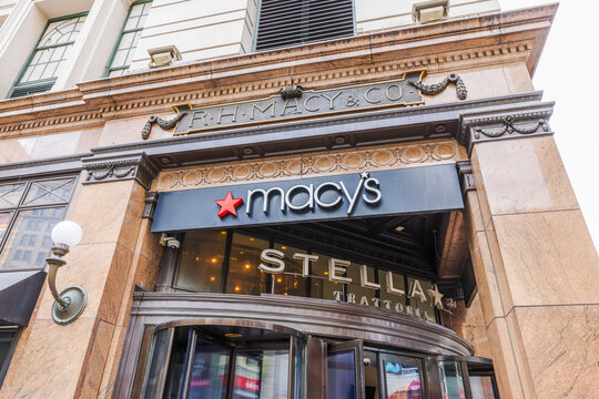 Close-up view of Macy's storefront entrance with R.H. Macy & Co. facade and Stellina Trattoria signage. New York. USA. 
