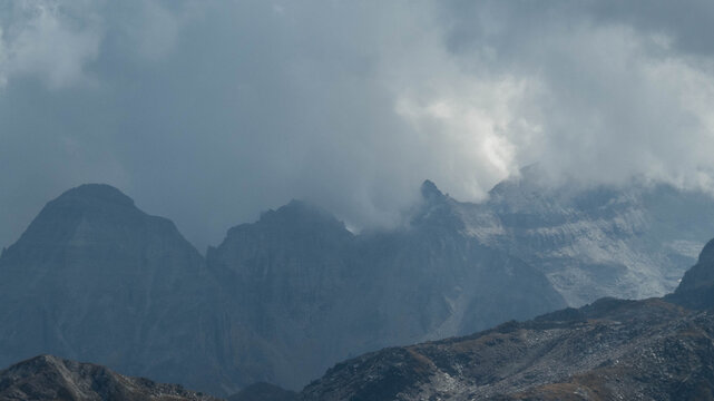 A powerful, close-up landscape photograph capturing the rugged, high-altitude peaks of a Swiss mountain range. 