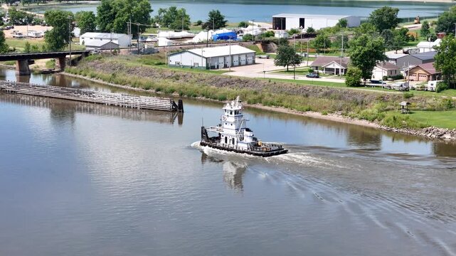 Service Tug Navigating the Mississippi River Through the Open Railroad Swing Bridge at Sabula, Iowa During Active River Traffic Operations