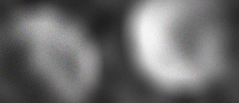 Abstract grainy light circles on a dark background