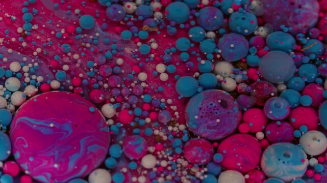 Bubbles fluid. Paint liquid. Defocused pink blue purple colorful water round droplets floating on abstract acrylic creative art background.