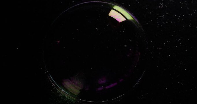 Sphere flare rotate. Colorful lens. Transparent round bubble light leak spin. Glossy mystic circle on black background copy space.