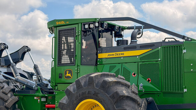 Regina, Canada - July 20, 2026: John Deere 948L-III forestry skidder cab and large Primex tire closeup at outdoor equipment display