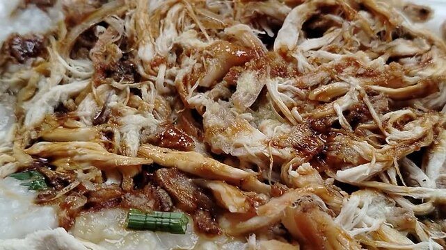 A delicious Indonesian chicken porridge menu served with tender shredded chicken, crispy fried shallots, fresh scallions, crunchy crackers, and savory seasonings. This traditional Asian breakfast is b