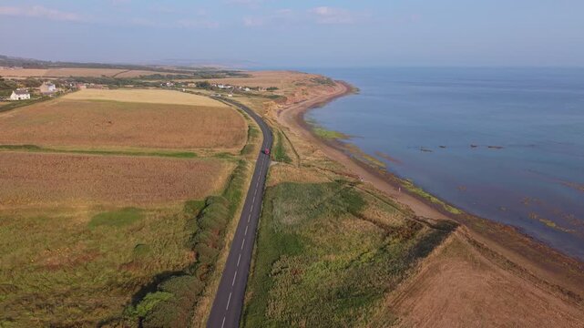 Aerial drone footage of Compton Bay and Brook Chine Beach on the south-west coast of the Isle of Wight, England, showcasing dramatic cliffs, golden sands, turquoise water, and the spectacular coast