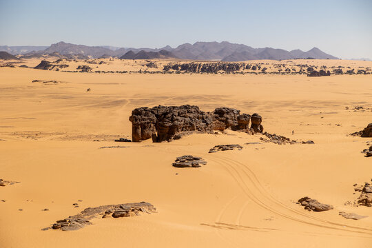 Rock Formation With Distant Desert Mountains