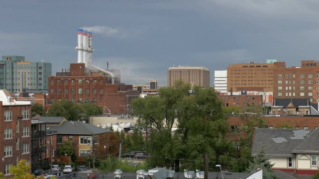 Cass Corridor Midtown north Detroit, Michigan and steam from the stacks of Detroit Thermal steam energy utility, Willis Avenue Station. Shot on a cloud and sun mixed afternoon in September 2022.