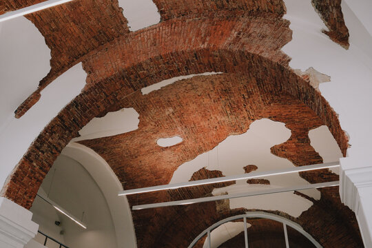 Historic brick vaulted ceiling integrated with modern interior during contemporary restoration of an old building