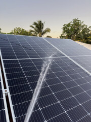 Obraz premium Cleaning solar panels from dust with water spray