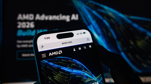Close up view of amd website on iphone 15 pro max screen, hand holding a smartphone.